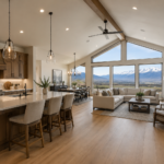 Open-concept custom home interior in Cache Valley, Utah with vaulted ceilings, mountain views, warm wood kitchen cabinetry, large island, pendant lighting, and connected family room.